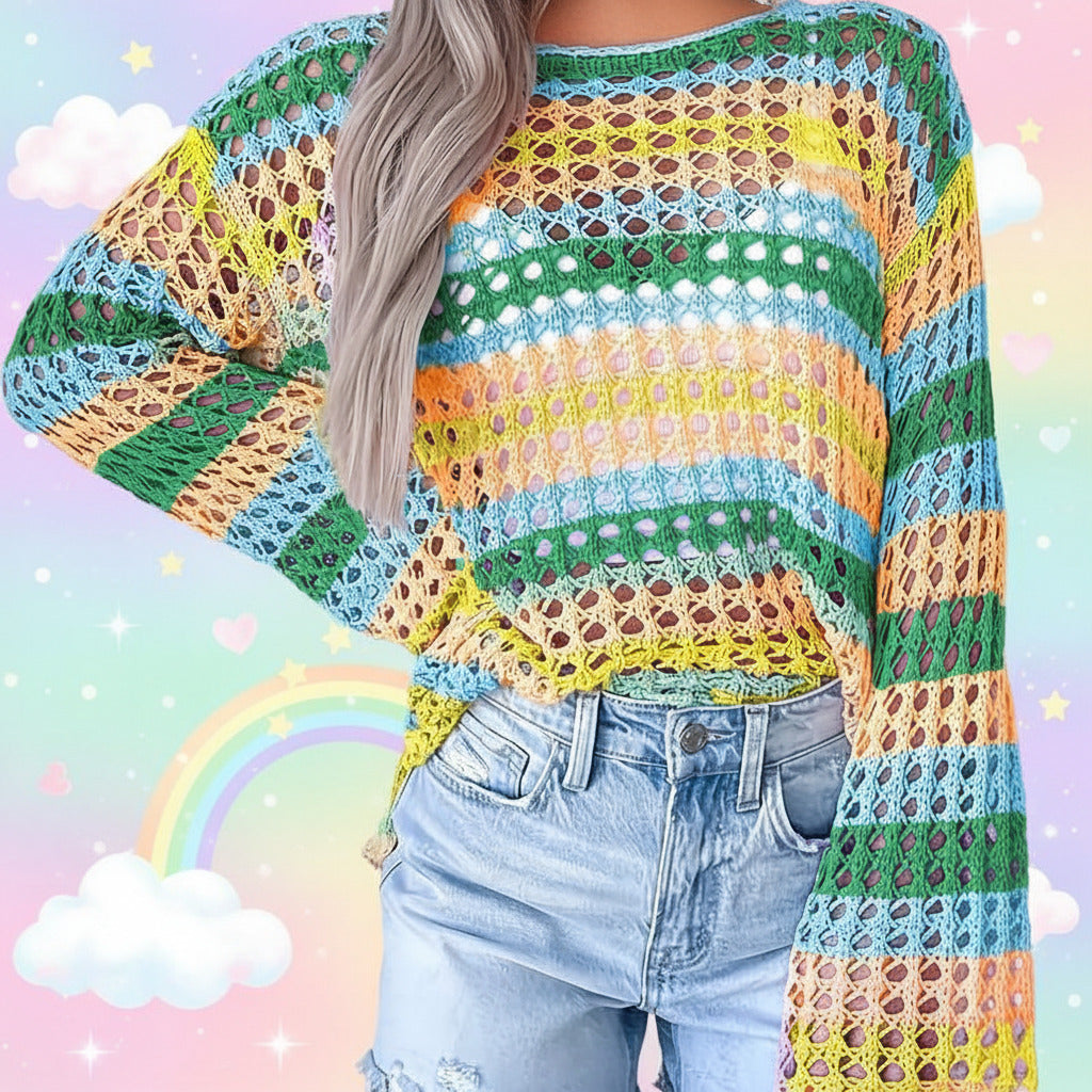 A person wearing a colorful open-knit crochet sweater with horizontal stripes in green, blue, yellow, orange, and pink, paired with light-wash denim jeans.