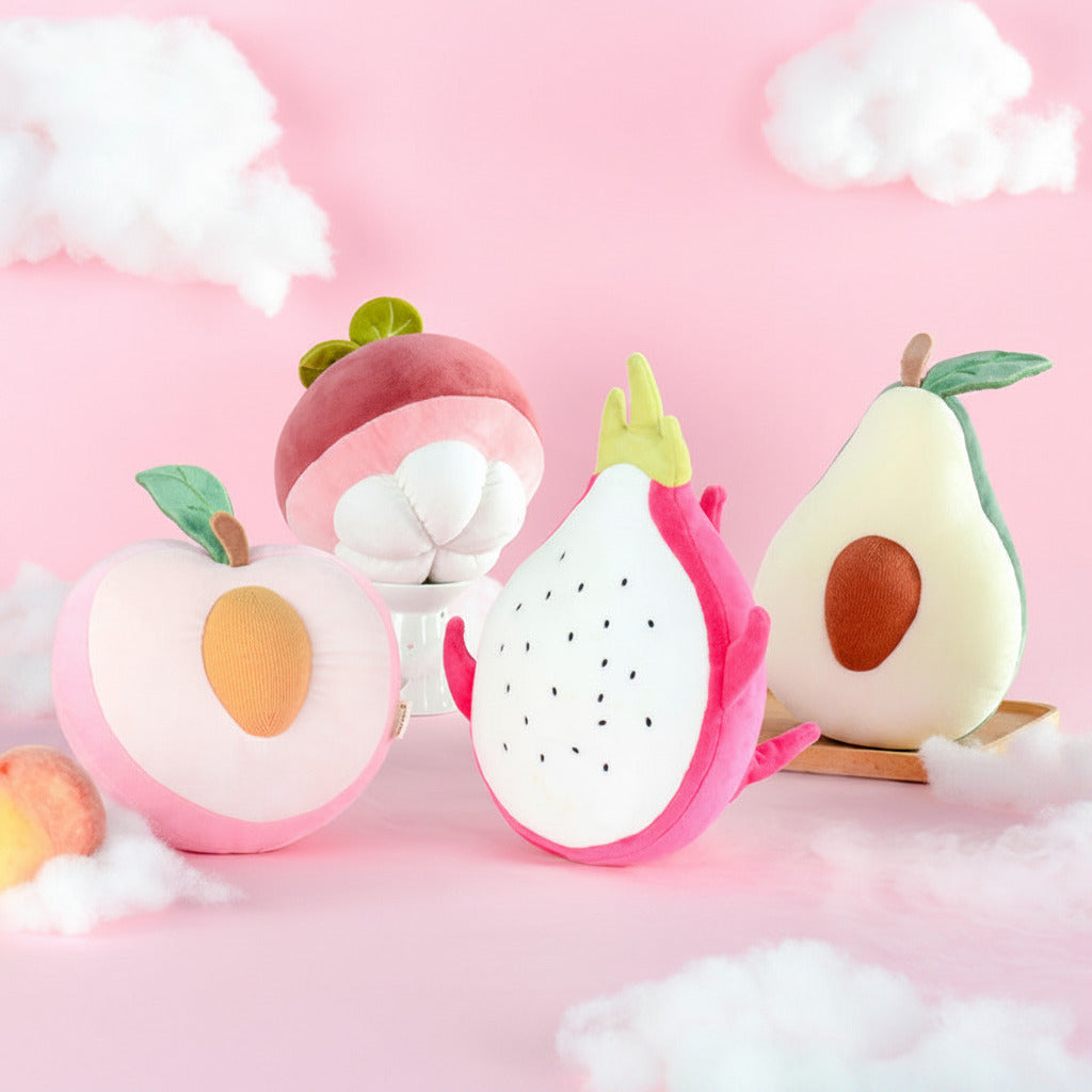 Plush toys shaped like fruits on a pink background