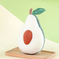 Avocado-shaped plush toy with a sliced avocado on a wooden board against a green background