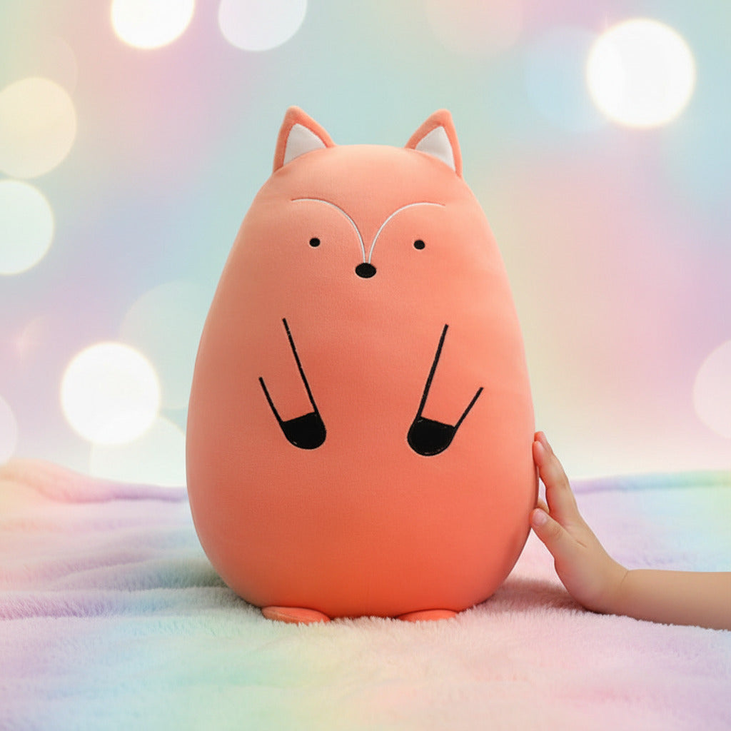 Plush fox toy on a bed with a blurred pastel rainbow background