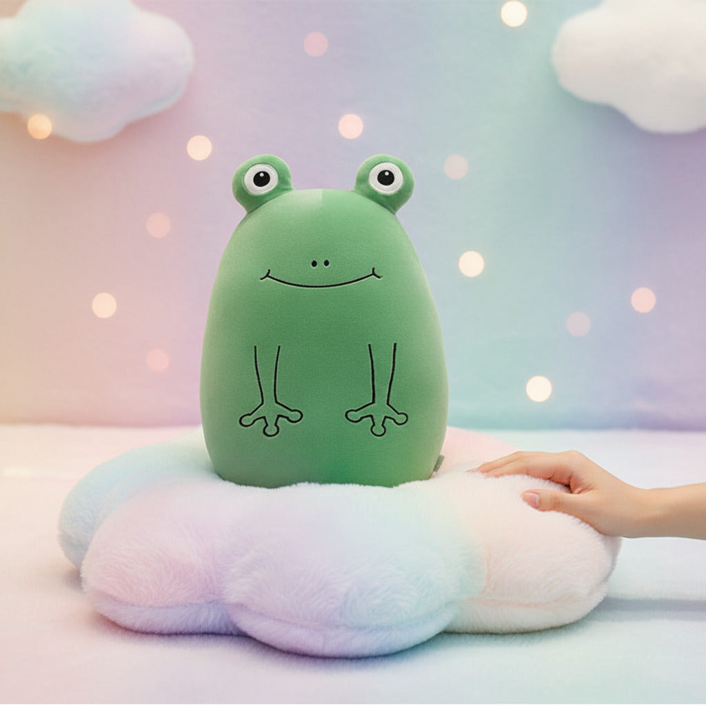 Green frog-shaped pillow on a bed with pillows and a plant in the pastel rainbow background