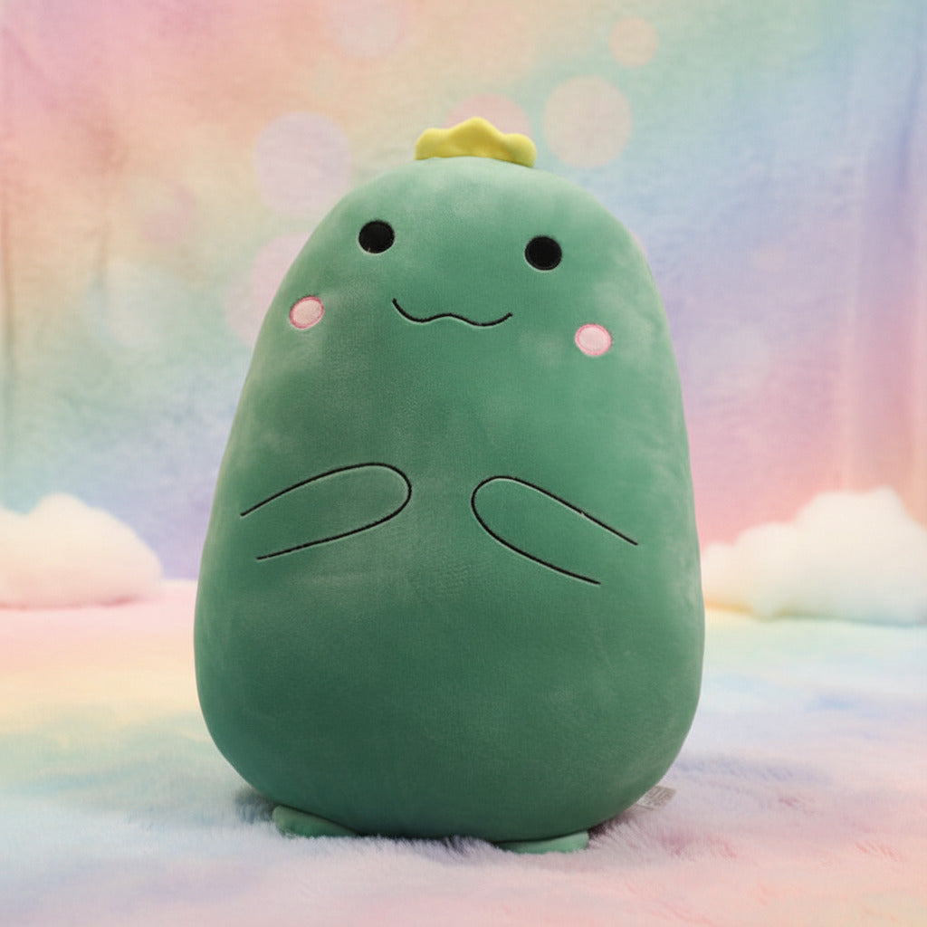 Green plush toy sitting on a bed and it's a pillow