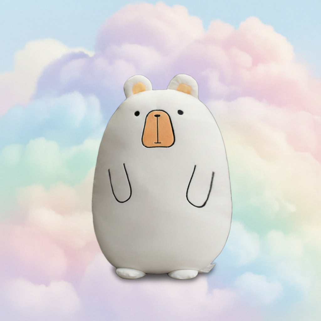 White plush pillow toy with bear face sitting on a cozy rug