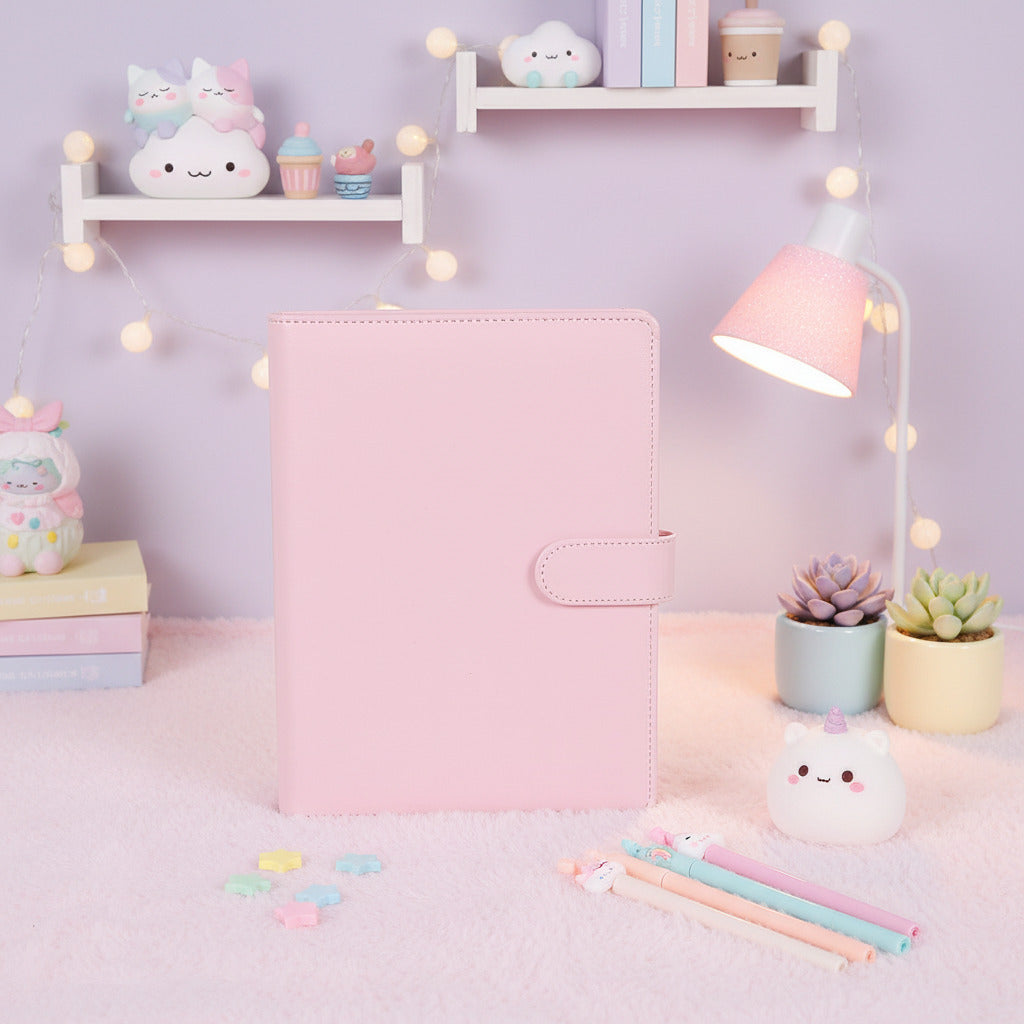 Pink kawaii ring binder notebook displayed on a wooden tabletop, featuring a clean aesthetic design perfect for journaling, planning, note-taking, school supplies, and cute Japanese-inspired stationery.
