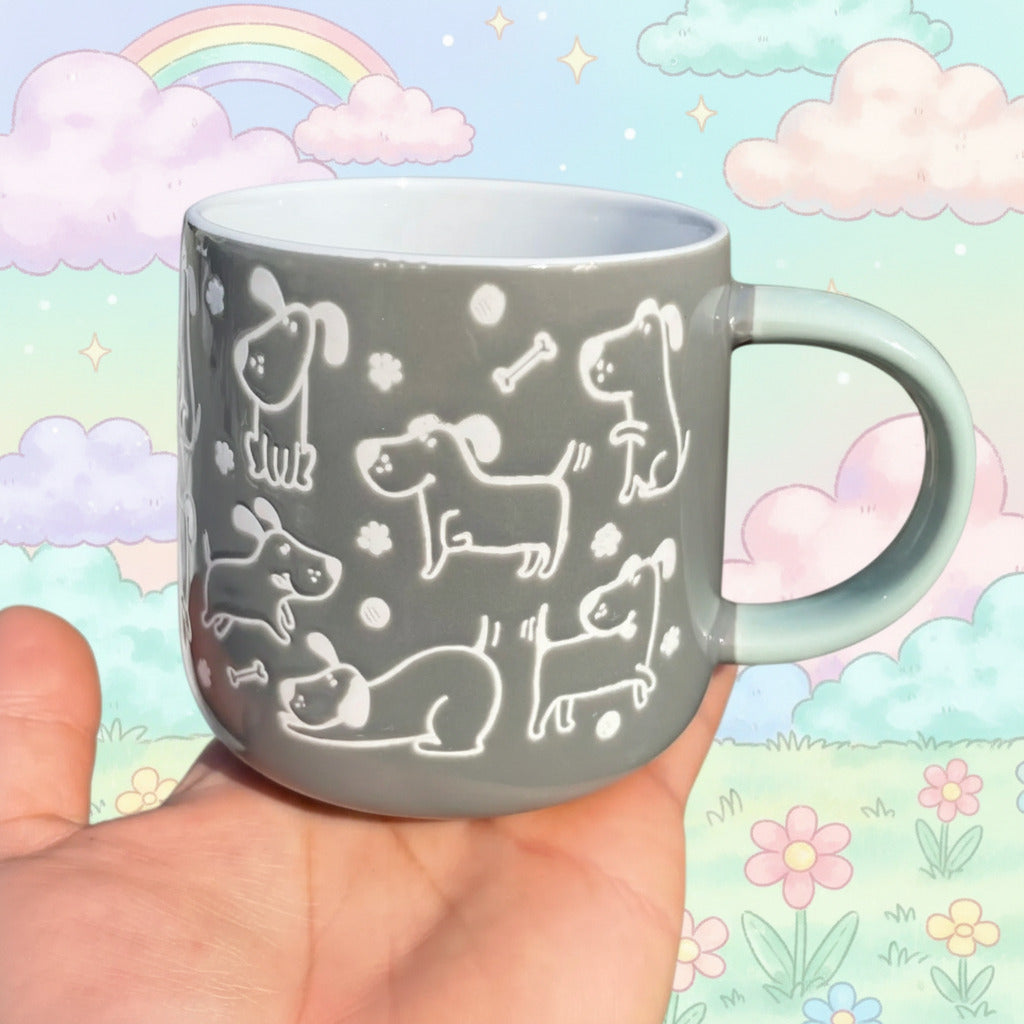 Gray mug with white dog illustrations held by a person kawaii outdoors