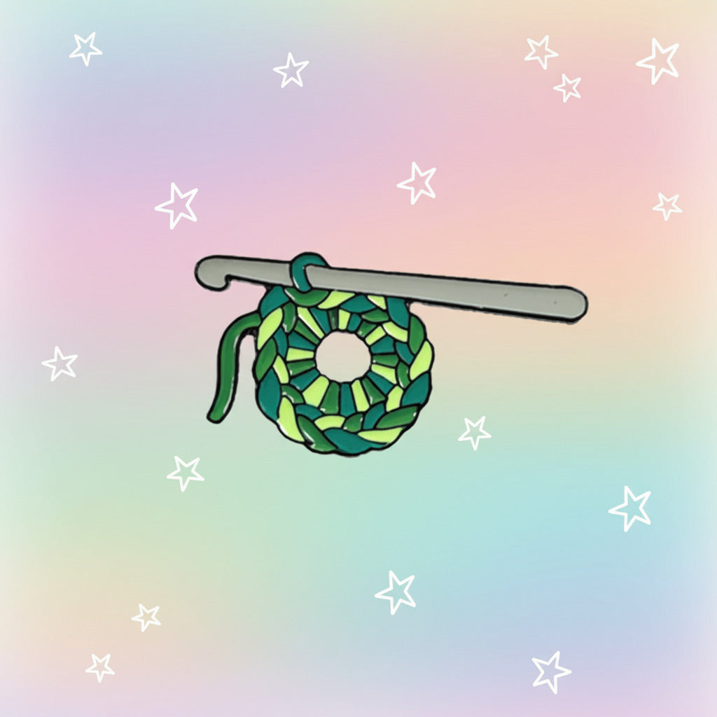 Crochet hook with green yarn on a white and pastel rainbow background