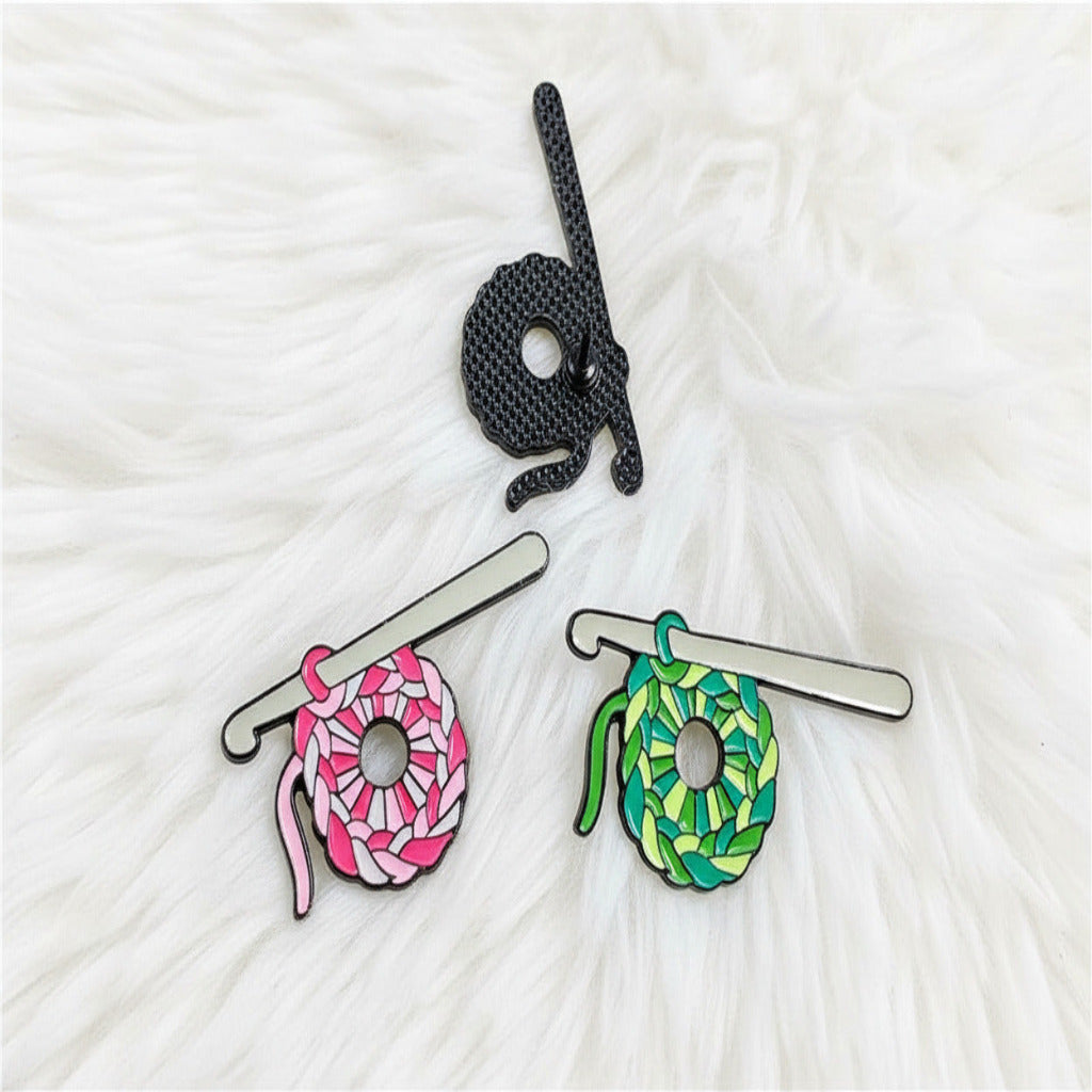 Colorful yarn ball and hook pins on a white furry surface
