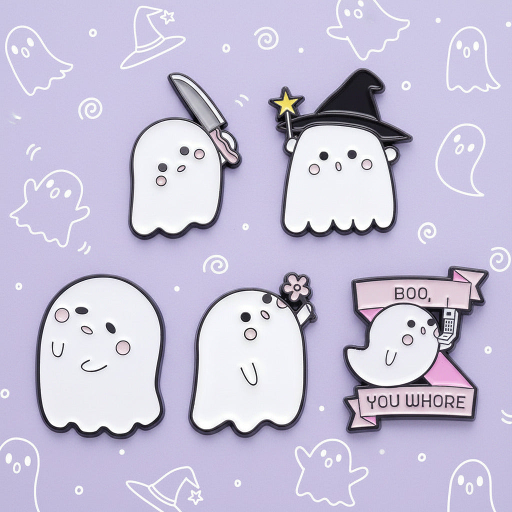 Five Halloween-themed ghost enamel pins on a plain white background, including a knife ghost, witch ghost, smiling ghost, flower-haired ghost, and a ghost holding a phone with a pink banner that reads 'BOO. YOU WHORE'.