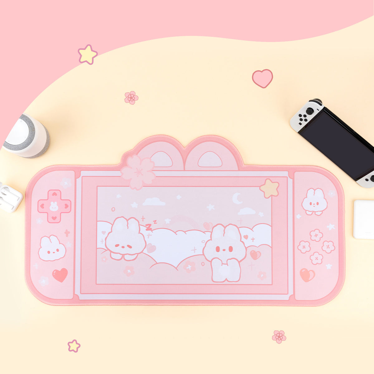 Pink gaming console with cartoon characters on a pink background