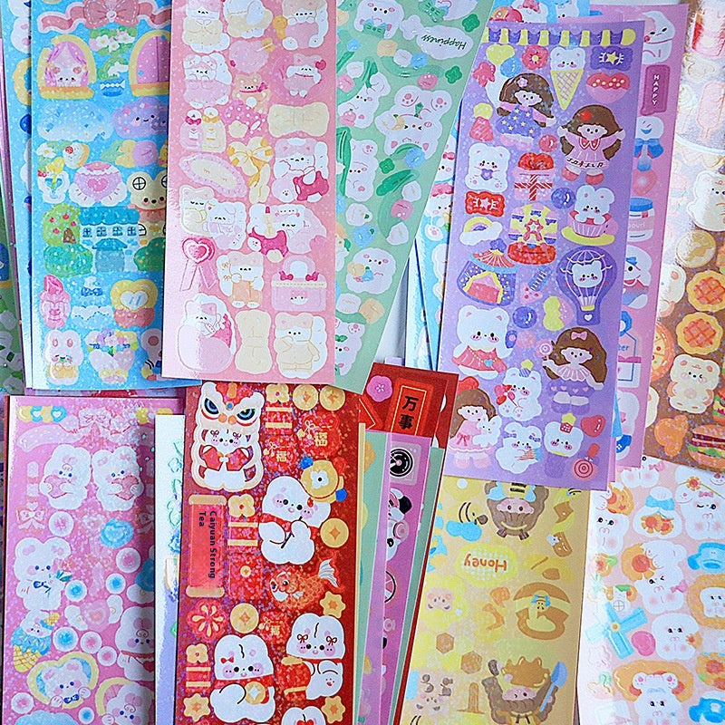 Collection of colorful stationery items with cartoon designs on a pink background
