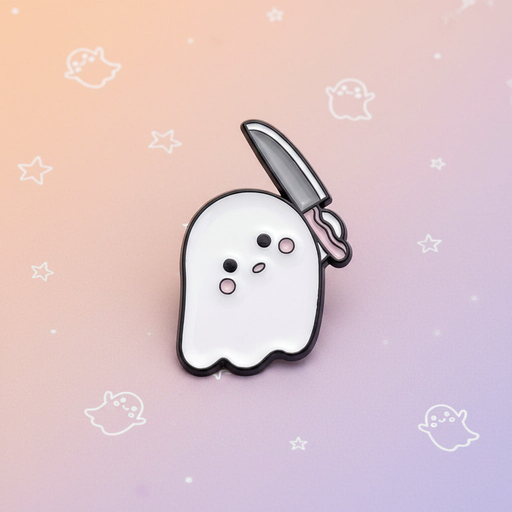 A cute ghost-shaped enamel pin with a knife in its mouth. The ghost is white with a black outline, simple black and pink eyes, and holds a gray knife with a pink handle.