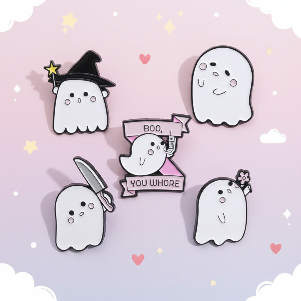 Five cute ghost-shaped enamel pins arranged on a pale mint background, including a witch hat, knife, banner reading 'BOO YOU WHORE,' and small flower details.
