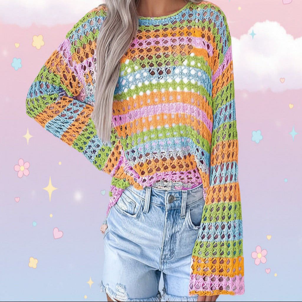 A person wearing a bright multicolor crochet knit sweater with horizontal stripes of orange, pink, green, blue, and yellow, paired with light-wash denim jeans.