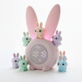 Pink rabbit-shaped clock with digital display on a white background