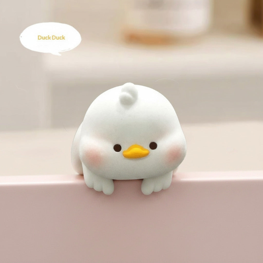White duck-shaped product with a yellow beak on a blurred background