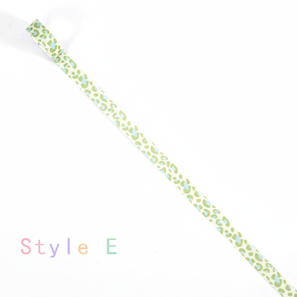 A roll of washi tape with a green and light blue leopard print pattern, shown diagonally on a white background with the text 'Style E' in the lower-left corner.