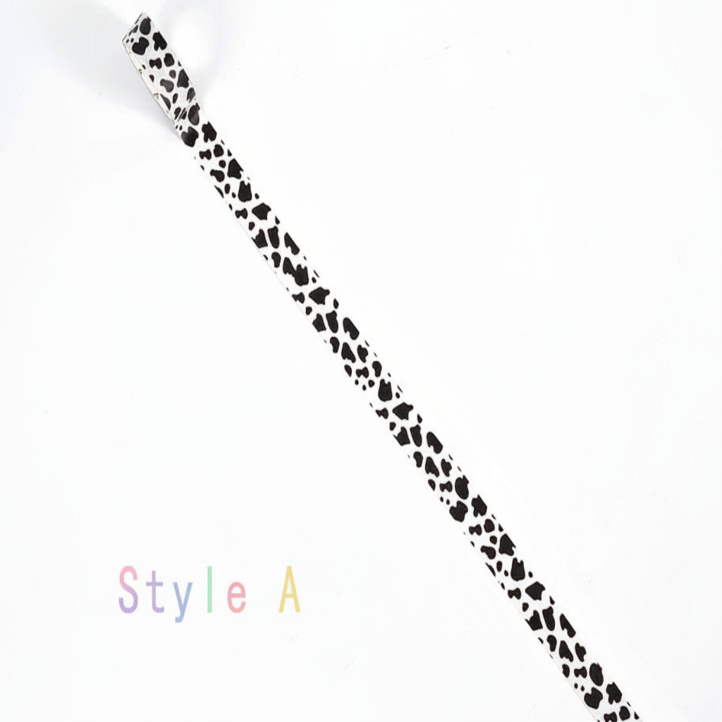 A white elastic band with a black cow print pattern, shown diagonally on a white background with the text 'Style A' in the bottom-left corner.
