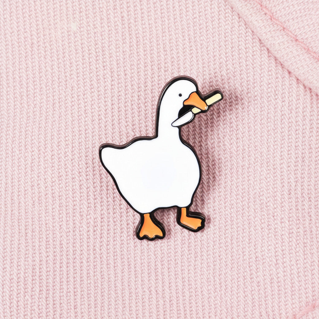 Geese-shaped enamel pin on a denim background