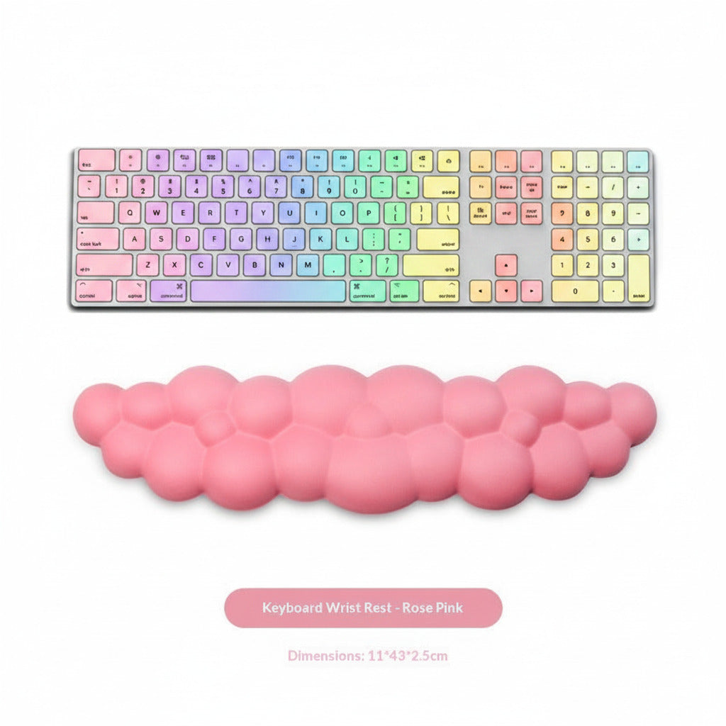 Rose pink keyboard wrist rest in front of a computer keyboard on a white background