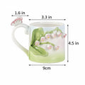Measurement chart of a ceramic mug with floral design and mushroom handle on a white background