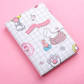 Notebook with cute illustrations on a pink background