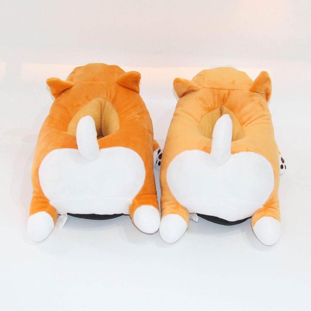 Pair of orange fox-shaped slippers on a white background