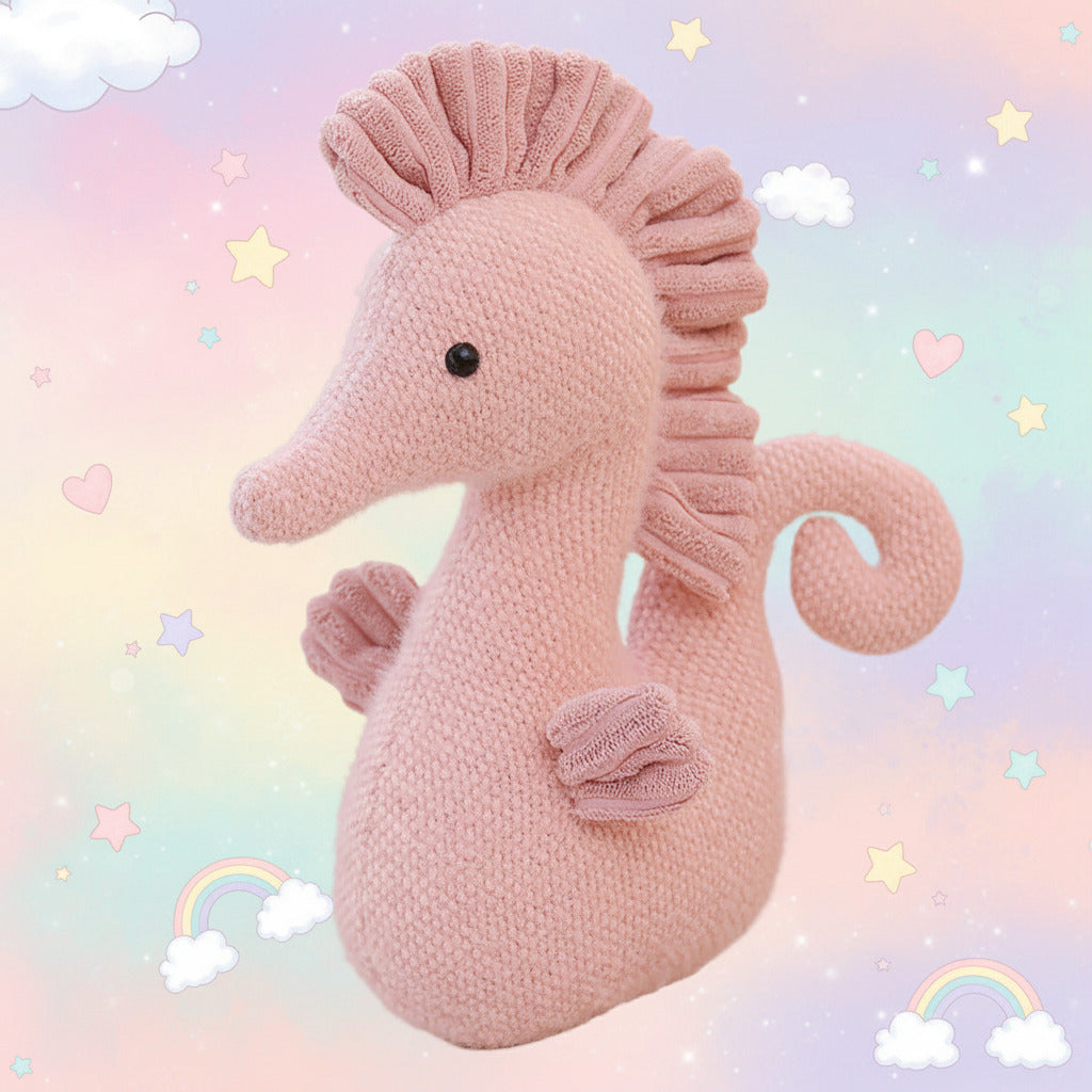 Pink knitted seahorse toy on a light background
