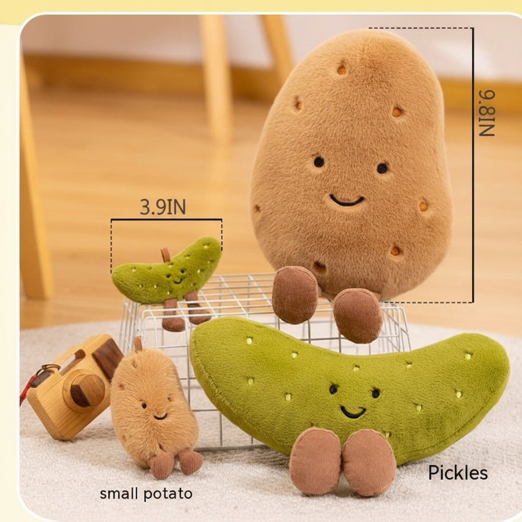 Three plush vegetable toys on a light rug in a softly blurred indoor setting: a large brown potato plush, a green pickle plush, and a small beige potato plush. White measurement lines and text show dimensions 25 cm, 10 cm, and labels 'small potato' and 'Pickles'.