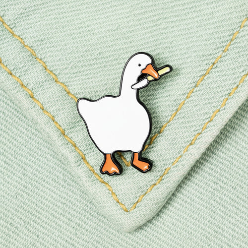 White duck pin on a denim fabric background