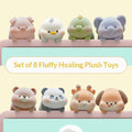 Set of 8 fluffy healing plush toys on a pink laptop shelf with a neutral background