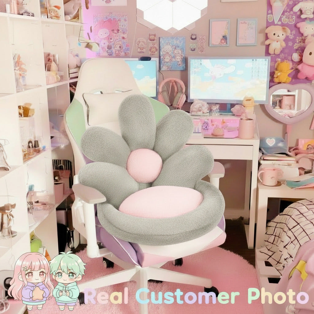 Decorative chair with pink and gray cushions in a room with a computer setup and teddy bears.
