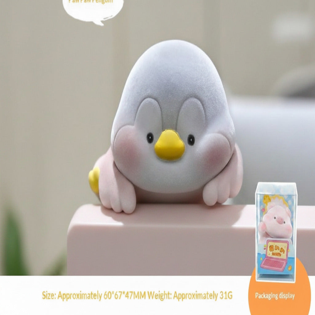 Plush penguin toy on a surface with packaging display in the corner.